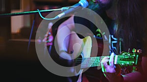 Guitarist at concert - acoustic guitar, microphone, club