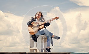 Guitarist entertaining guests at party. small music lover. free music content. Teenage musician playing guitar. Portrait