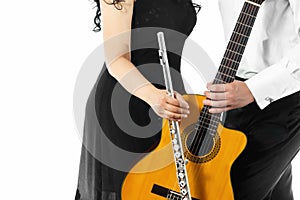 The guitarist and flutist are holding instruments in their hands. A classic guitar and flute duet concept