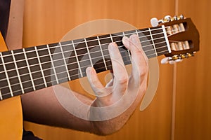 Guitarist hand playing acoustic guitar