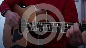 Guitarist hands and guitar close up.