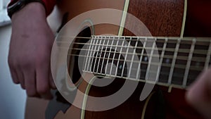 Guitarist hands and guitar close up.