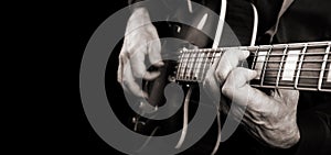 Guitarist hands and guitar close up. playing electric guitar. copy spaces. black and white.