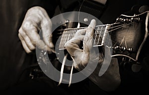 Guitarist hands and guitar close up. playing electric guitar. copy spaces. black and white.