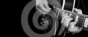 Guitarist hands and guitar close up. playing electric guitar. copy spaces. black and white.