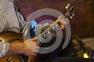 Guitarist hands play an electric guitar