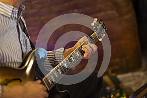 Guitarist hands play an electric guitar