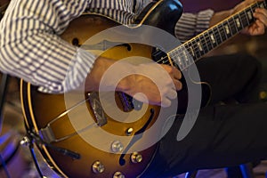 Guitarist hands play an electric guitar