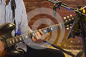 Guitarist hands play an electric guitar