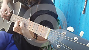 Guitarist hands playing song on acoustic guitar