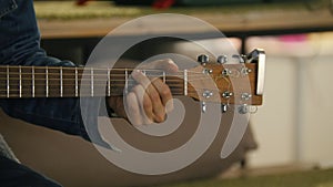 Guitarist holds acoustic guitar near microphone at concert in club, extremely close up