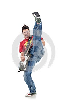 Guitarist kicking while performing