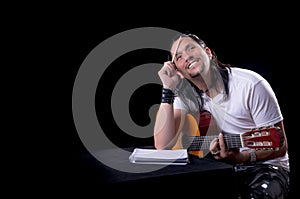 Guitarist musician writing a song on his guitar