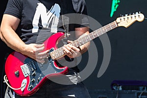 Guitarist play electricity guitar on concert stage