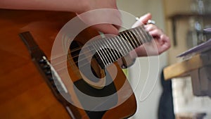 Guitarist playing acoustic guitar - Guitarists hands