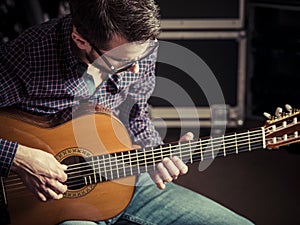 Guitarist playing acoustic guitar in studio