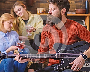 Guitarist playing at birthday, celebration concept. Bearded man performing guitar solo. Man with stylish beard