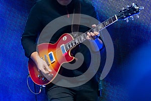 Guitarist playing electric guitar at live concert