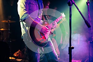 Guitarist playing electrical guitar on a rock gig