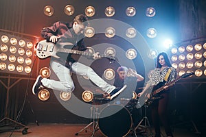 Guitarist plays on bas-guitar, snapshot in a jump