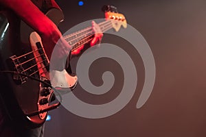 Guitarist plays bass guitar at a concert