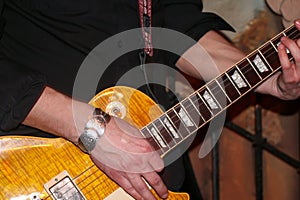 The guitarist plays a close -up of an electric guitar