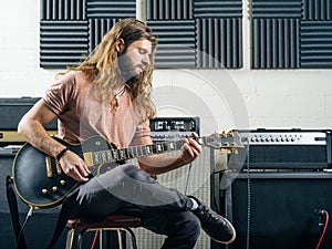 Guitarist recording tracks in the studio