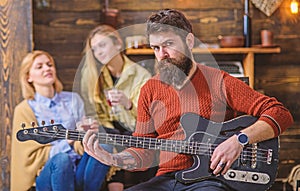 Guitarist rehearsing new show. Bearded man entertaining his wife and daughter with lovely tunes. Rock musician on