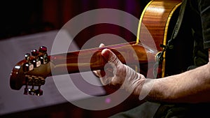 guitarist's hand on a guitar neck