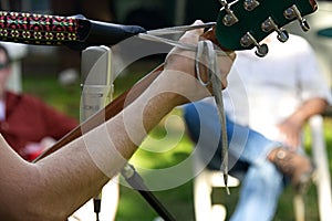 Guitarist`s hand view from behind