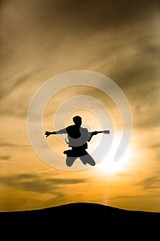 Guitarist silhouette jumping