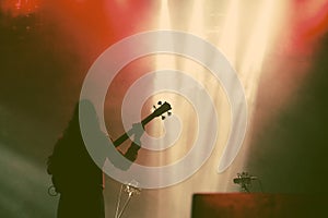 Guitarist silhouette in smoke during concert