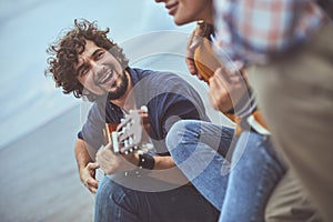 Guitarist singing a song to his friends