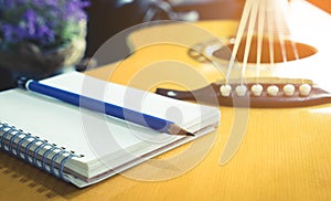 Guitarist Songwriter with blank notebook and pencil