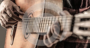 Guitarist on stage. Close up hand playing guitar. Guitars acoustic. Male musician playing guitar, music instrument