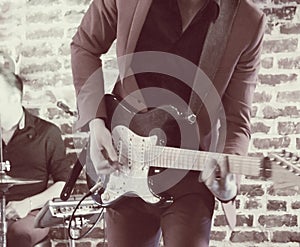 Guitarist on stage closeup defocused vintage style image