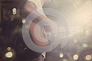 Guitarist on stage grunge background, vintage and retro color tone