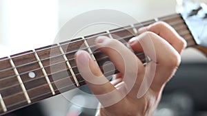 Guitarists hands playing song on electric guitar