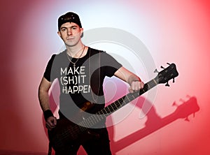 Guitarists of a rock band with guitar on red background