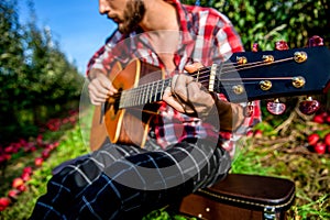 Guitars acoustic. Male musician playing guitar, music instrument. Man& x27;s hands playing acoustic guitar, close up