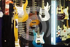 Guitars of different colours in music store