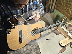 Guitars Luthiers sets up a stand under the arm. photo