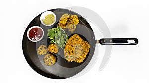 Gujarati Snacks Muthia In Different Shape On Nonstick Pan With Green Chutney And Ketchup Sauce