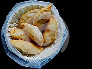 Gujiya,pedakiya,karanji,Kajjikayalu is a sweet deep-fried dumpling Shaped like a half-moon, made with suji or maida stuffed with