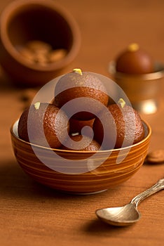 Gulab Jamun in bowl and copper antique bowl with spoon. Indian Dessert or Sweet Dish