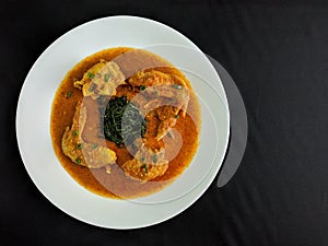 Gulai Ayam is traditional Indonesian dish of chicken cooked in a spicy, rich, yellowish, curry-like sauce called gulai