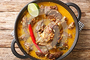 Gulai Kambing or Indonesian Traditional Delicious Goat Curry closeup on the pan. Horizontal top view photo