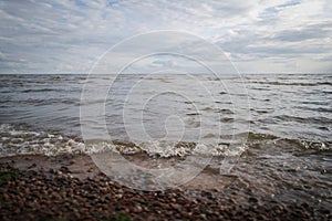 Gulf of finland beach with shallow water on a cloudy day