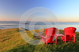 Gulf Islands National Park and Reserve, Red Adirondack Chairs in Evening Light at East Point, Saturna Island, BC, Canada