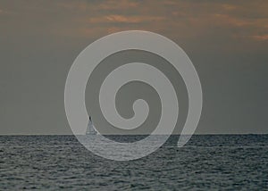 Sailboat againt the horizon during the end of a Gulf of Mexico sunset